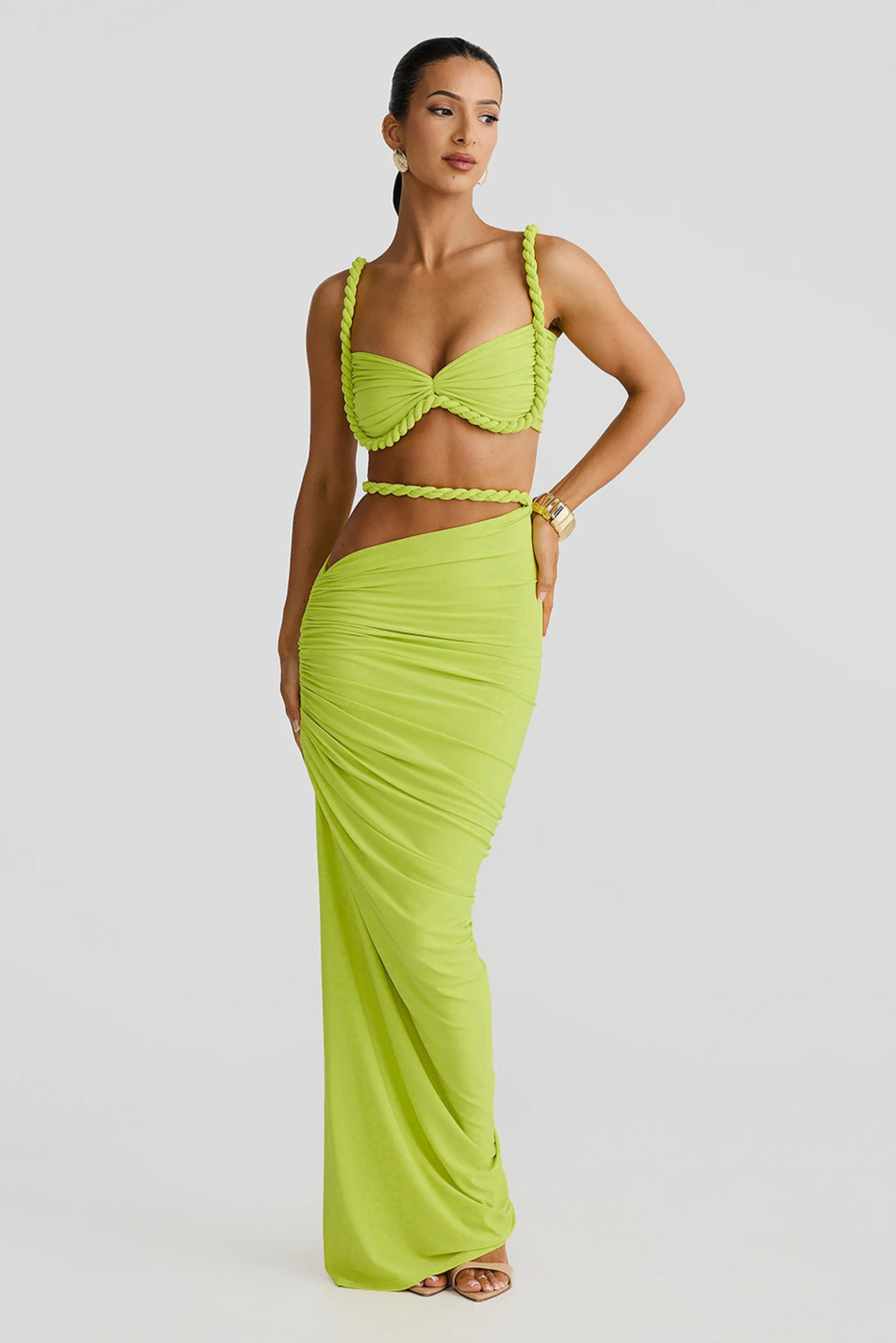 Full-length front view of a lime green ruched cut out strapless maxi 2 piece set, featuring a twisted rope top and draped skirt.