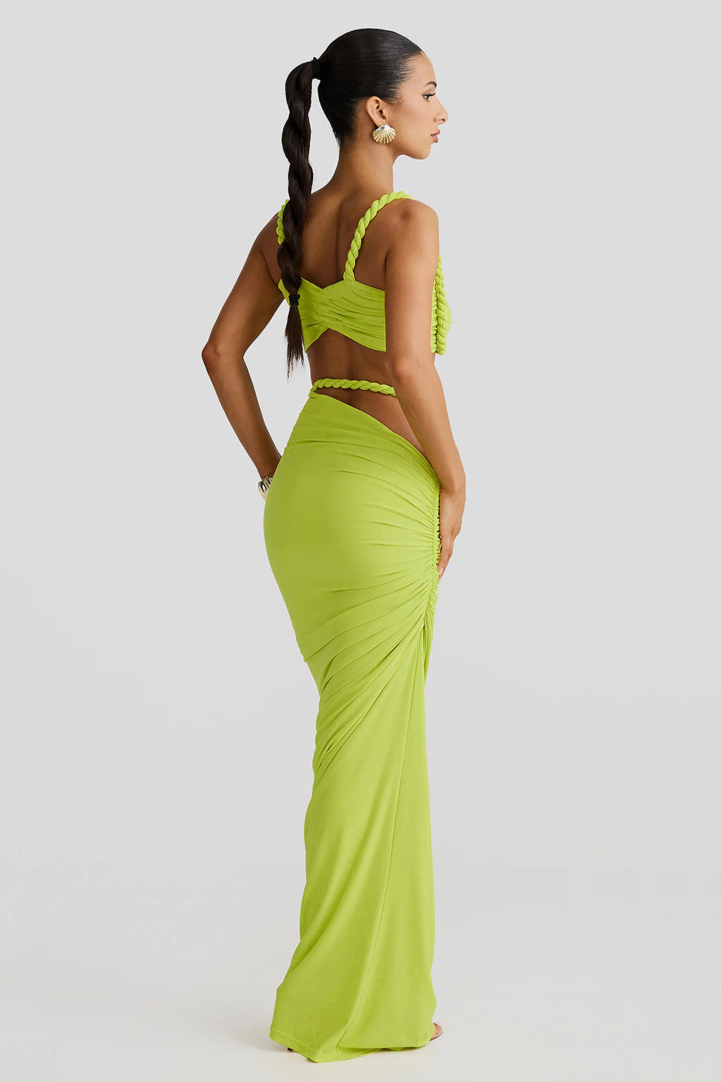 Back view of a lime green ruched cut out strapless maxi 2 piece set, showing the twisted rope straps and ruched detailing on the skirt.