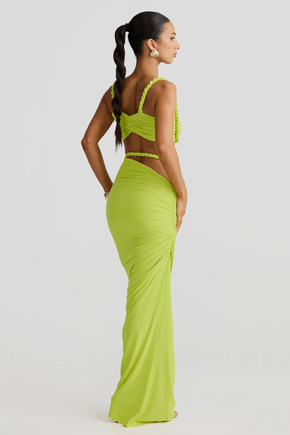 Back view of a lime green ruched cut out strapless maxi 2 piece set, showing the twisted rope straps and ruched detailing on the skirt.