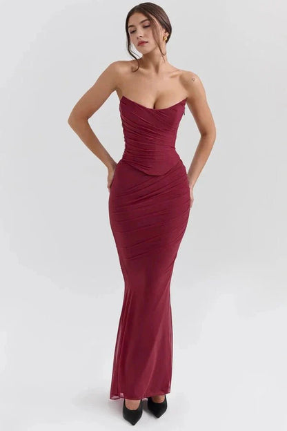 Model wearing the Hailey burgundy ruched maxi dress as a strapless corset gown, front view.