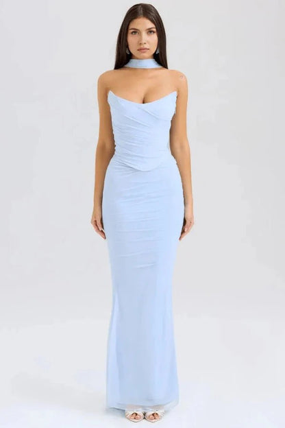 Model wears the Hailey light blue corset prom dress, featuring a draped strapless bodice, ruched mesh maxi skirt, and a choker neck detail, shown from the front.
