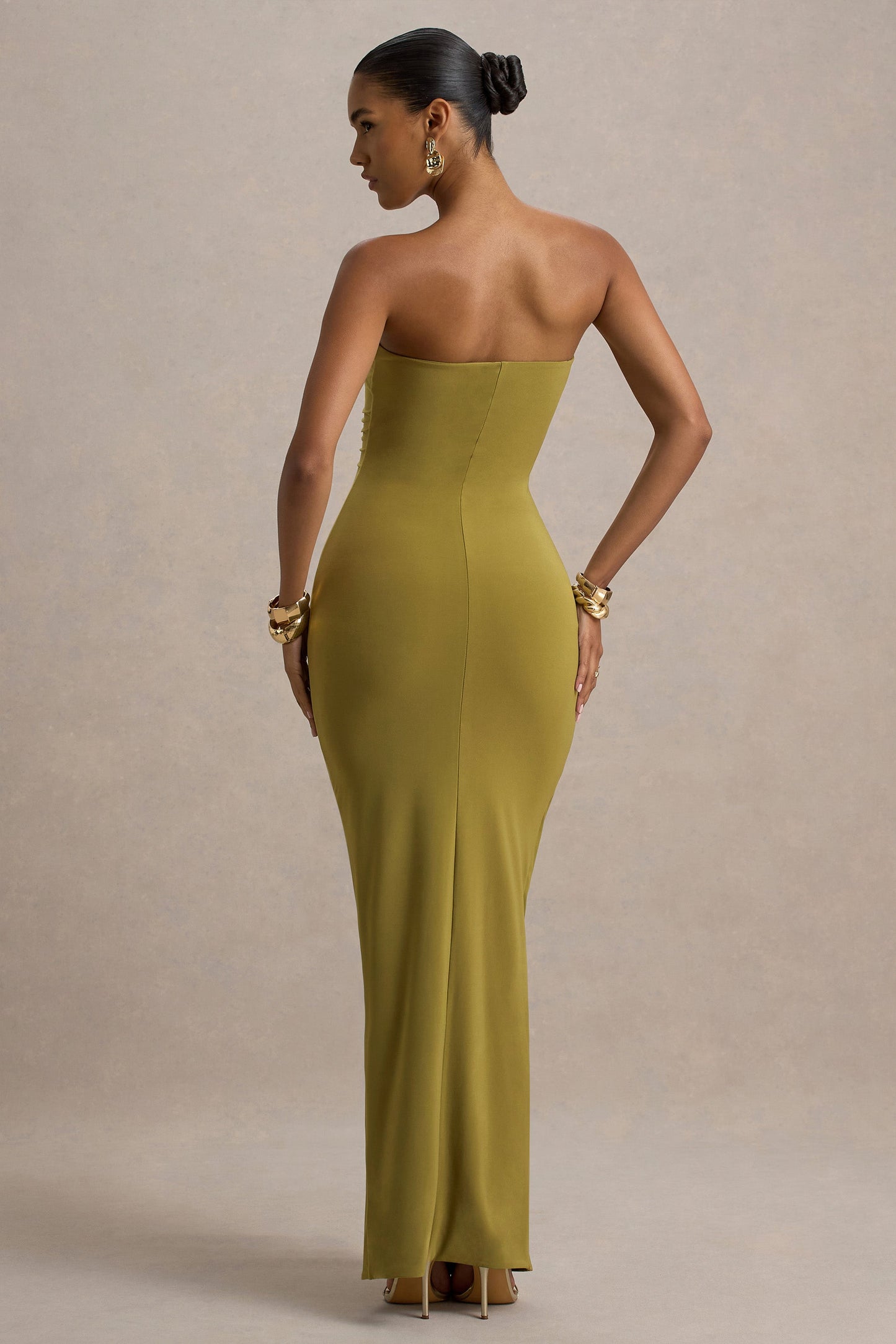 Back view olive green off shoulder slinky jersey maxi dress with clean back seam and fitted silhouette
