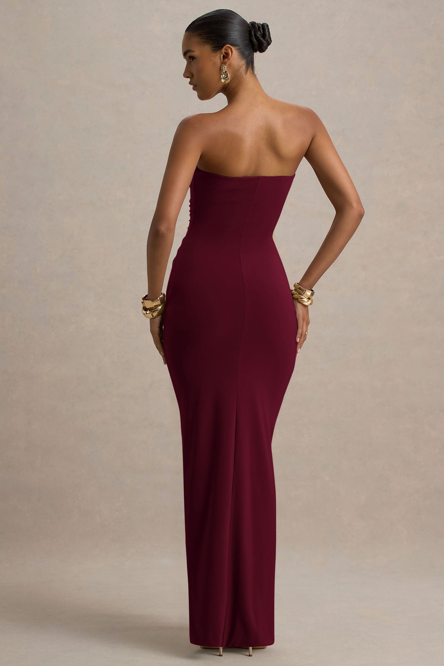 Back view burgundy off shoulder slinky jersey maxi dress with smooth back and fitted bodycon silhouette