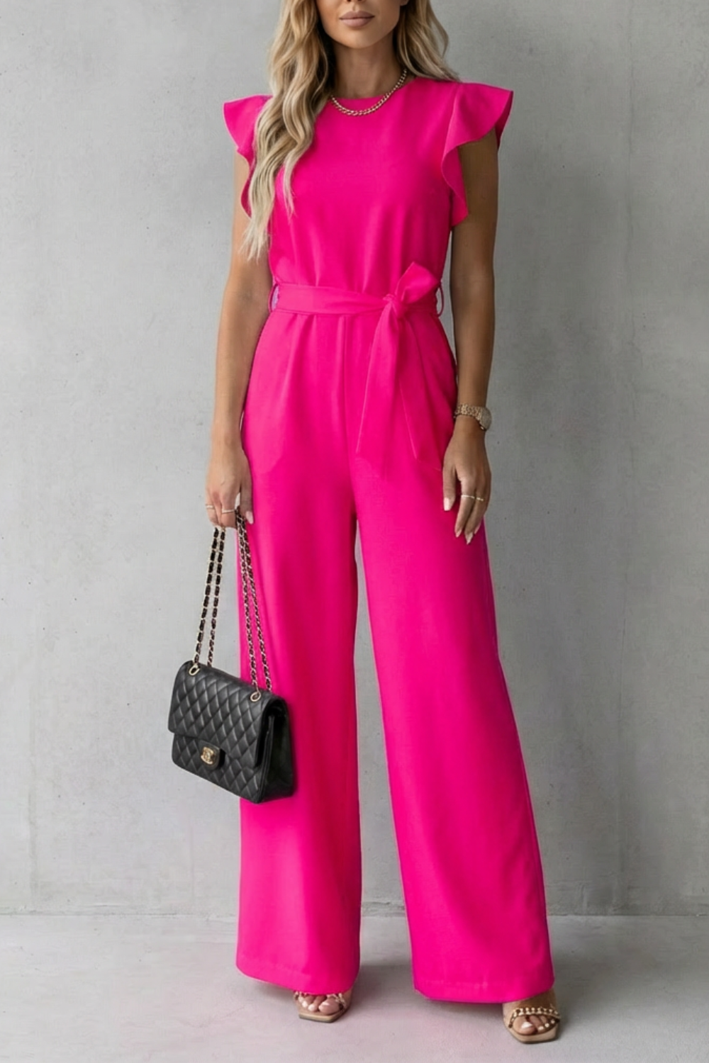 Bright pink ruffle sleeve wide leg jumpsuit with a matching self-tie belt, chic and vibrant.