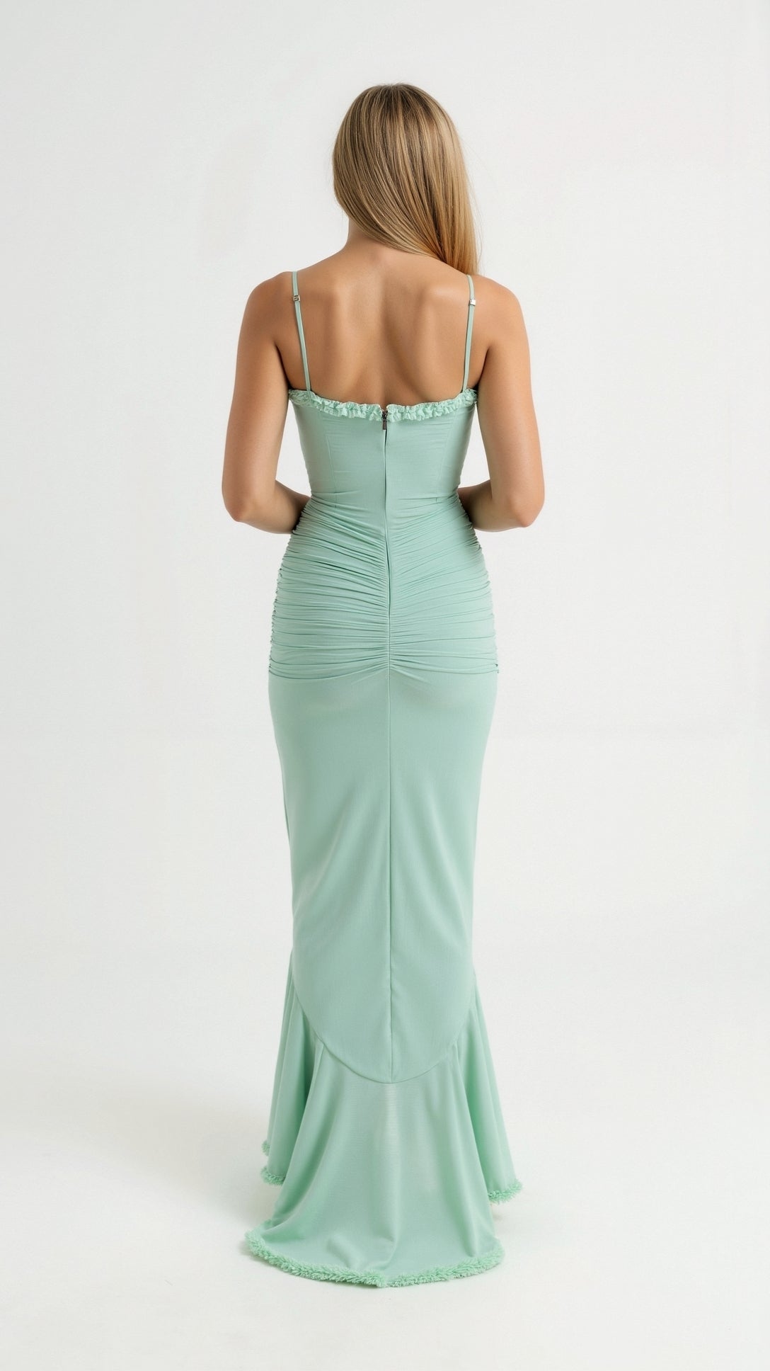 Rear view of a mint green sleeveless ruched ruffle high-low maxi dress, emphasizing the form-fitting ruched back.