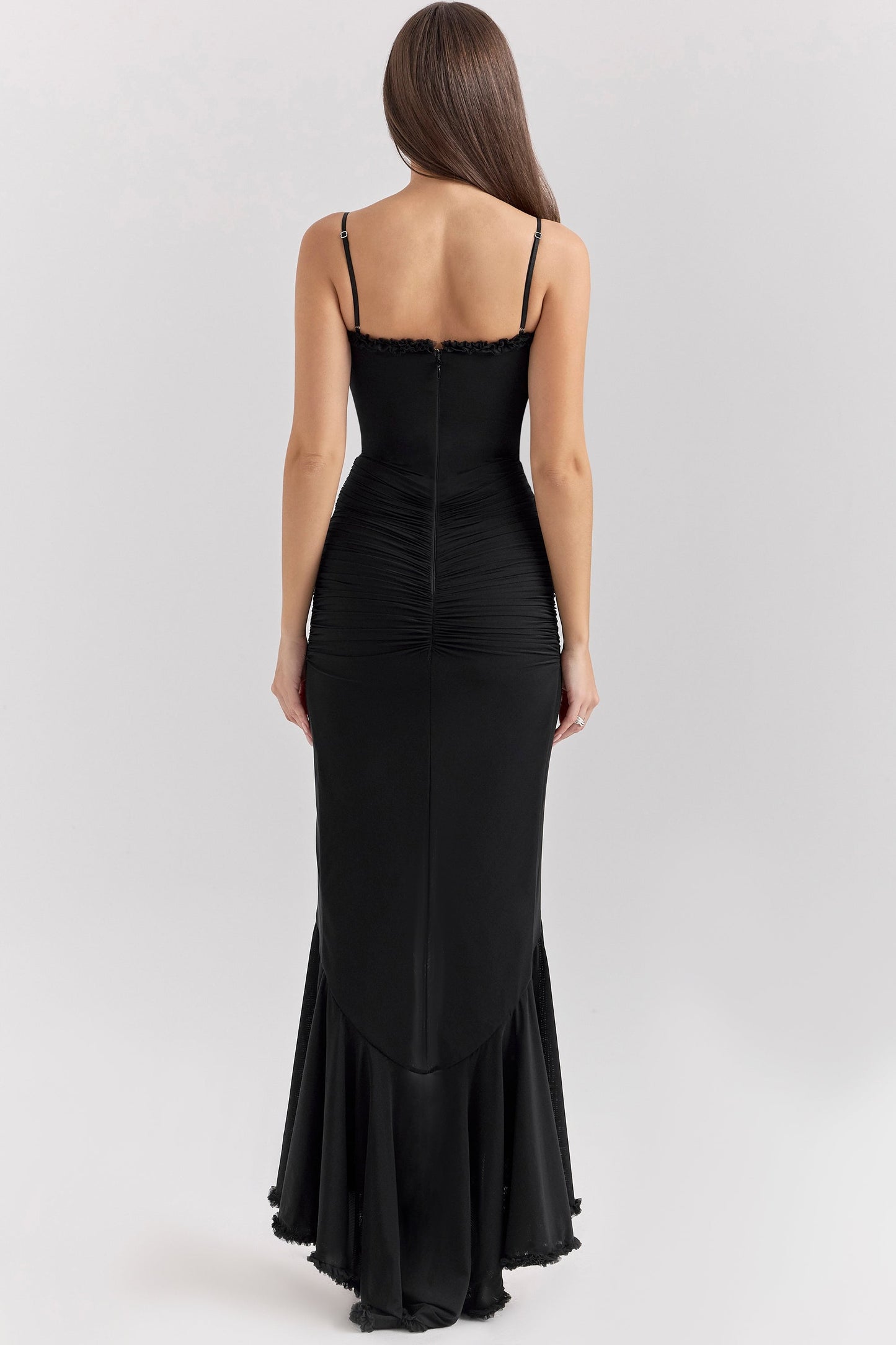 Back view of a black sleeveless ruched ruffle high-low maxi dress, highlighting the elegant silhouette and ruffled detailing.