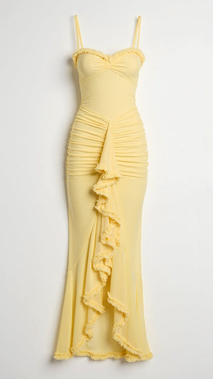 Close-up of a yellow sleeveless ruched ruffle high-low maxi dress, showing the detailed ruching and tiered ruffles.