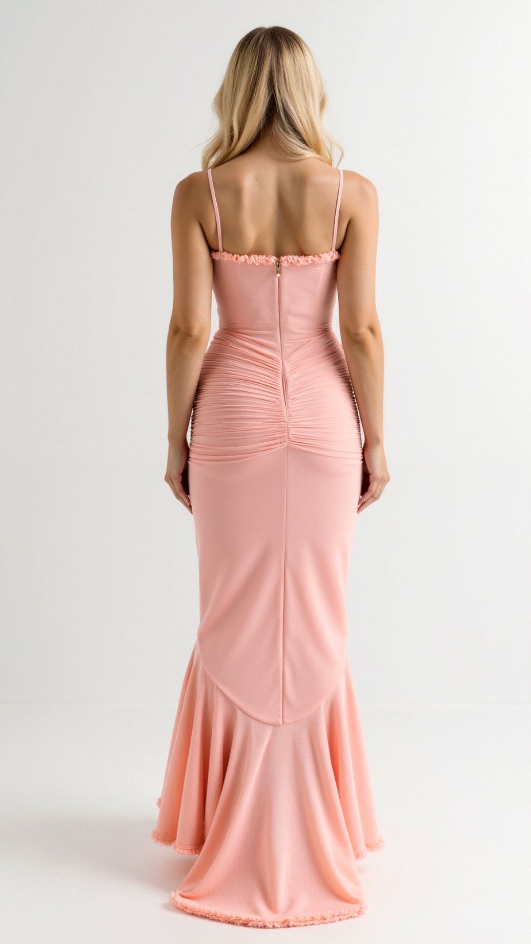 Back view of a peach sleeveless ruched ruffle high-low maxi dress, revealing the subtle zipper and elegant train.