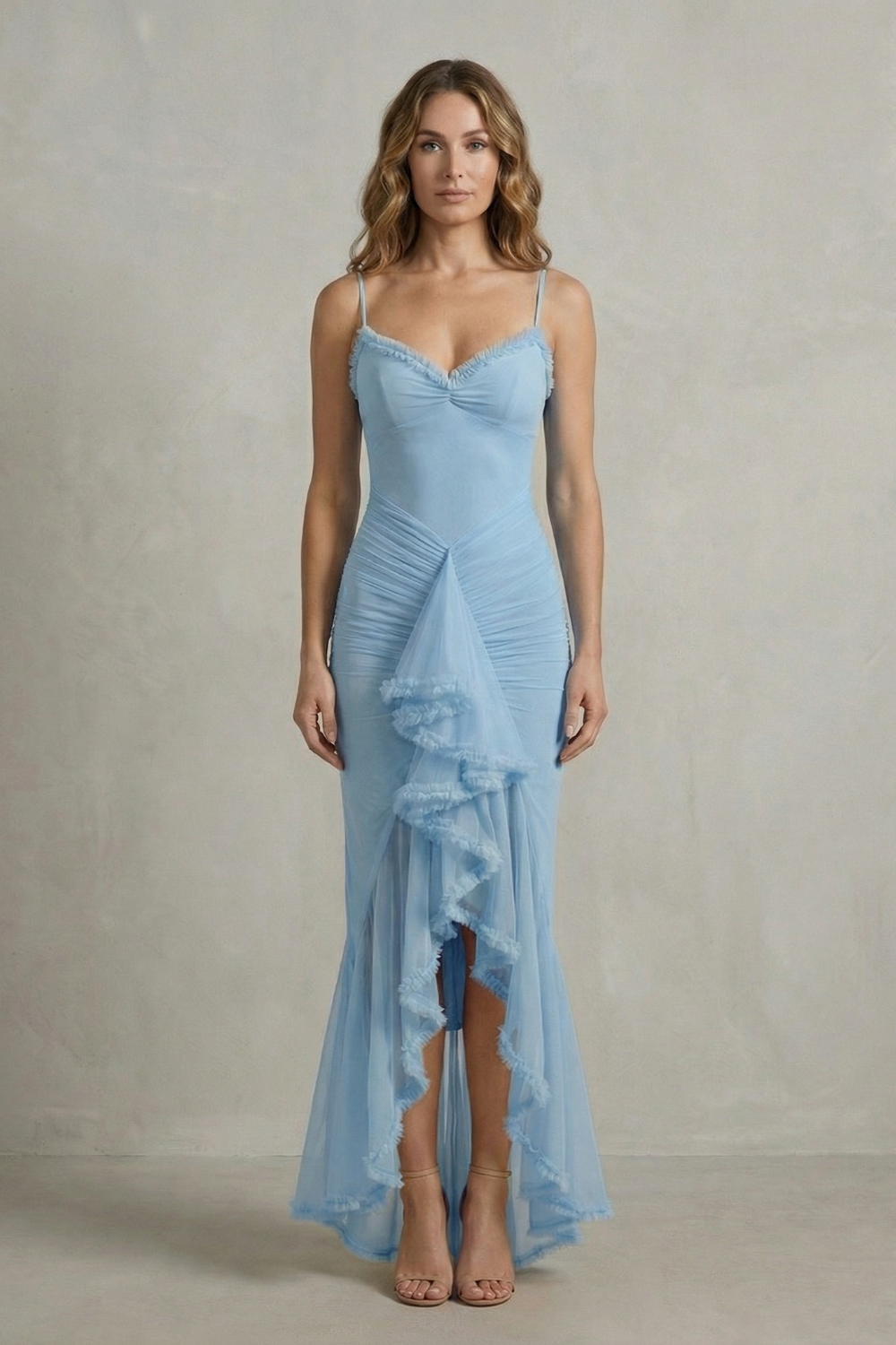 Full-length front view of a woman wearing a light blue sleeveless ruched ruffle maxi dress, a beautiful beach dress for women.