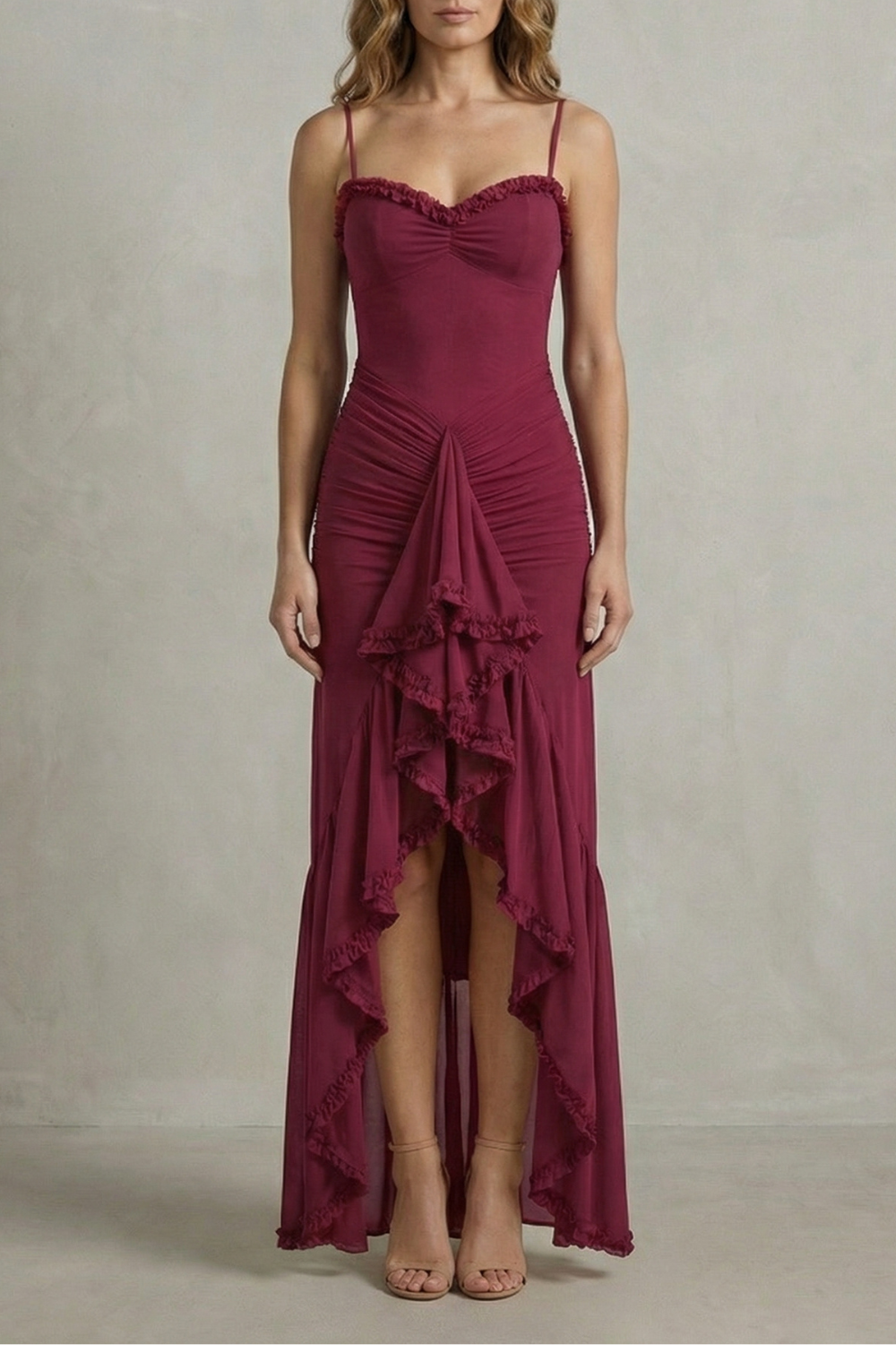 Front view of a women's sleeveless ruched ruffle maxi dress in a deep burgundy, featuring a sweetheart neckline and a high-low hem with cascading ruffles, perfect for wedding guests.