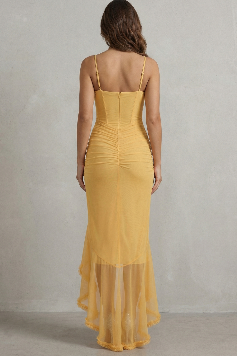 Back view of a yellow sleeveless ruched ruffle maxi dress, showing the corset-style back and gathered fabric detail.