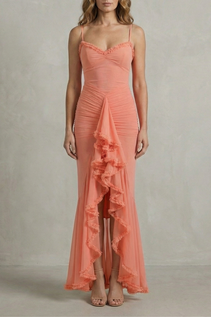 Front view of a coral sleeveless ruched ruffle maxi dress with delicate spaghetti straps, an elegant dress for wedding guests.