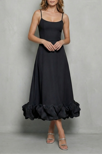 Black sleeveless midi dress featuring delicate spaghetti straps and a dramatic ruffled hem, ideal for a black satin dress or midi dress with sleeves.