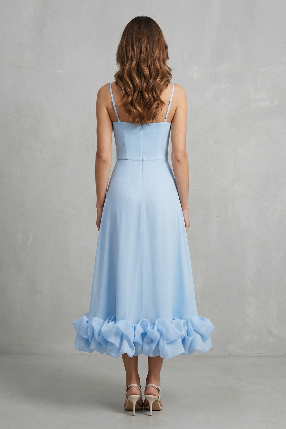Back view of a light blue sleeveless midi dress for women, showcasing the zipper closure and the distinctive ruffled hem detail.