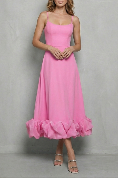 Vibrant pink sleeveless midi dress with a sweetheart neckline and a playful ruffled hem, a stylish choice for vacation outfits.