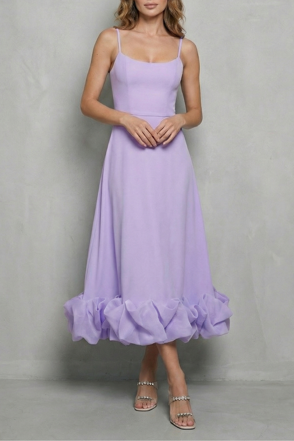 Charming lavender sleeveless midi dress with thin straps and a voluminous ruffled hem, suitable for elegant dresses for wedding guests.