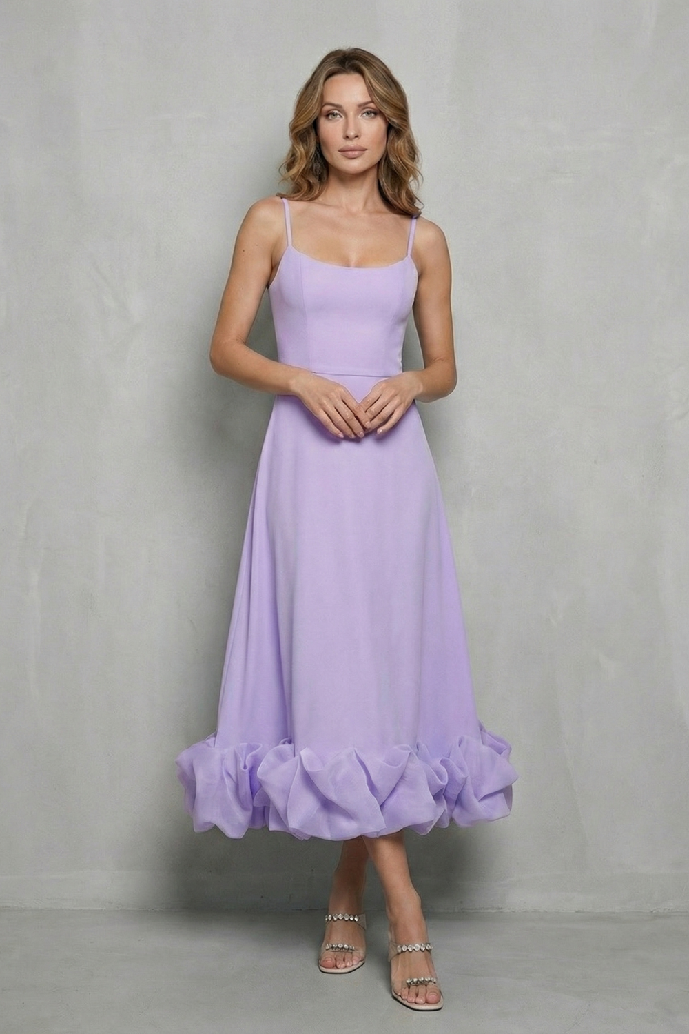 Front view of a women's delicate lavender sleeveless midi dress, featuring spaghetti straps and a full, ruffled hemline.