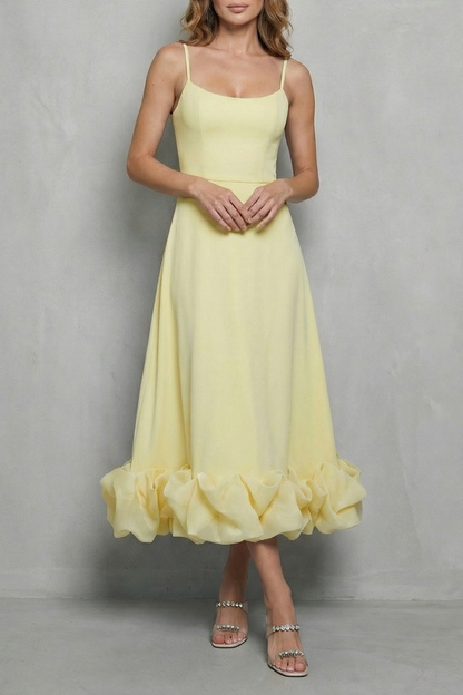 Soft yellow sleeveless midi dress with a fitted bodice, spaghetti straps, and a unique ruffled hem, a lovely option for beach dress for women.