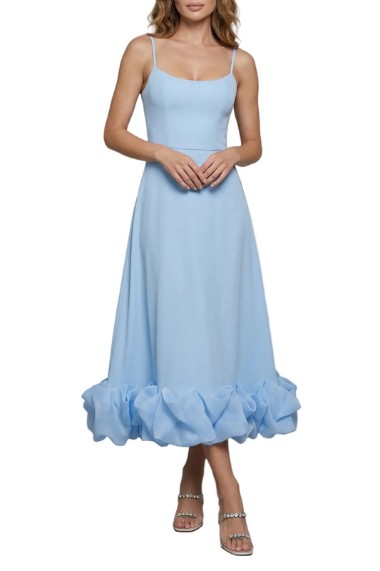 Sleeveless light blue midi dress with spaghetti straps and a voluminous ruffled hem, suitable for vacation dresses.