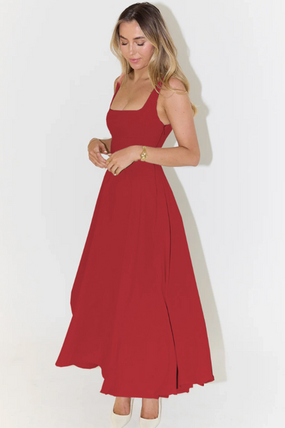 Red square neck sleeveless midi dress for women, featuring a flowing A-line skirt and subtle side slit, paired with white heels.
