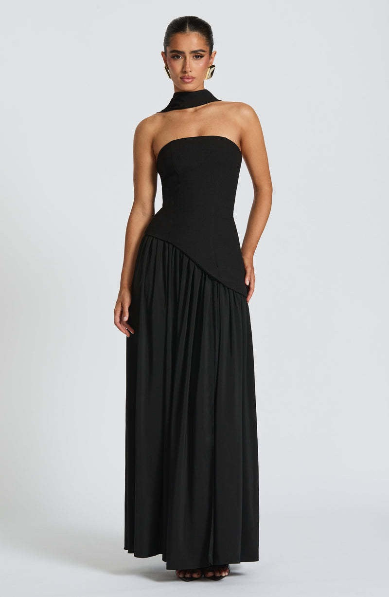 Black strapless asymmetric corset maxi dress featuring a structured bodice and a gathered floor-length skirt.
