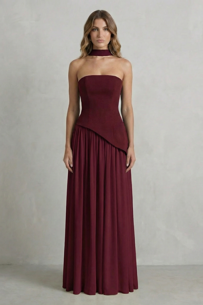 Deep burgundy strapless asymmetric maxi dress with a structured bodice and a gracefully falling skirt, perfect for womens wedding guest dresses.