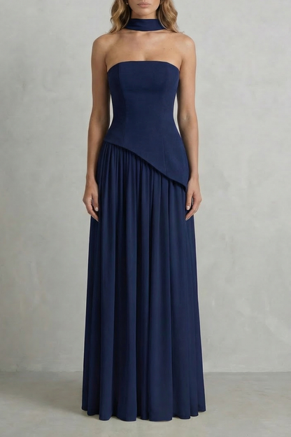 Navy blue strapless asymmetric maxi dress featuring a structured bodice and a gracefully pleated skirt, ideal for formal events.