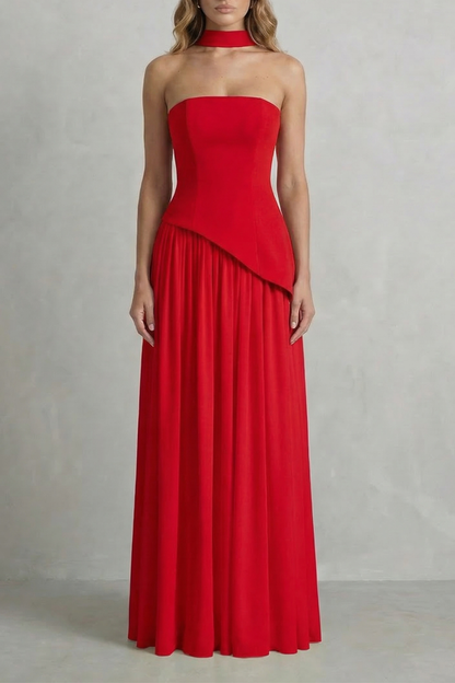Vibrant red strapless maxi dress with an asymmetric overlay on the bodice and a floor-length pleated skirt, a bold vacation dress.