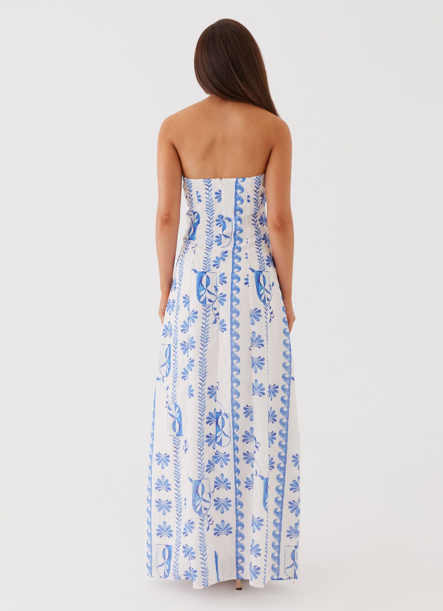 Back view of the women's strapless blue floral A-line maxi dress, showcasing the full pattern.