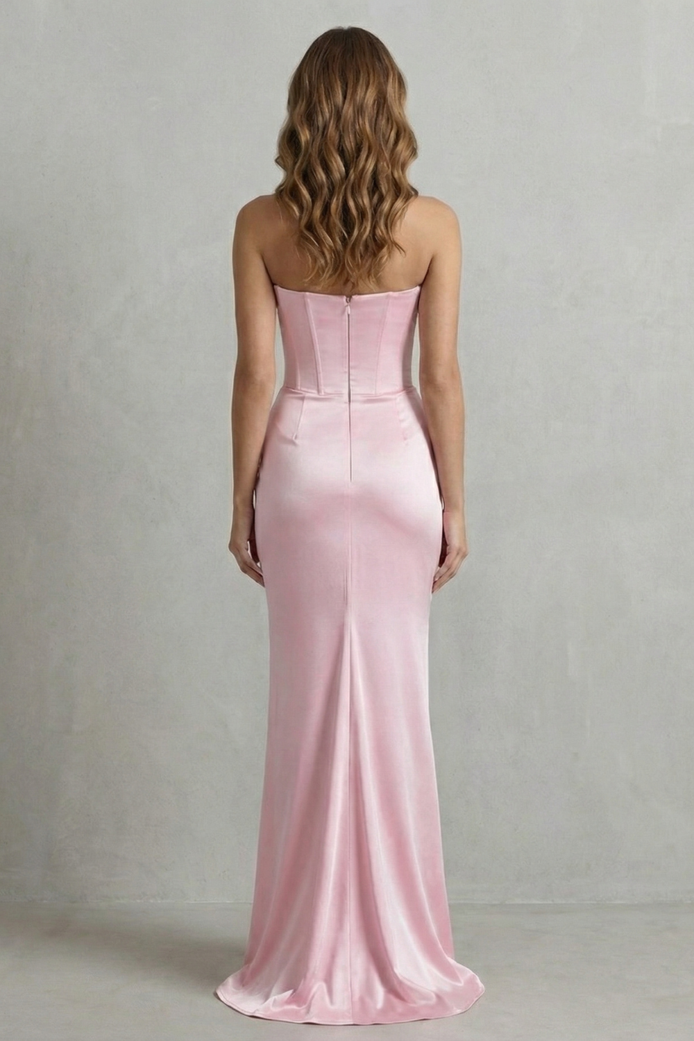 Back view of a pink strapless satin maxi dress, showing the smooth fabric and subtle train, ideal for wedding guests.