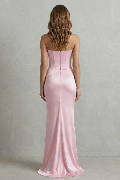 Back view of a pink strapless satin maxi dress, showing the smooth fabric and subtle train, ideal for wedding guests.
