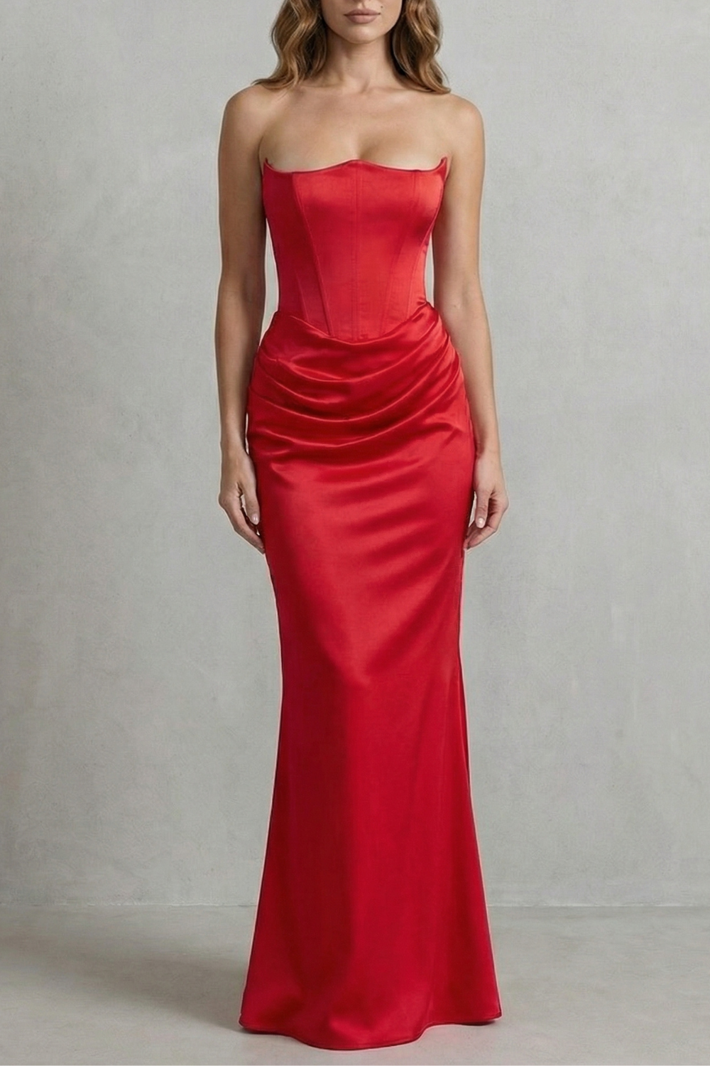 Full-length view of a vibrant red satin maxi dress with a strapless corset top and draped detailing on the skirt.