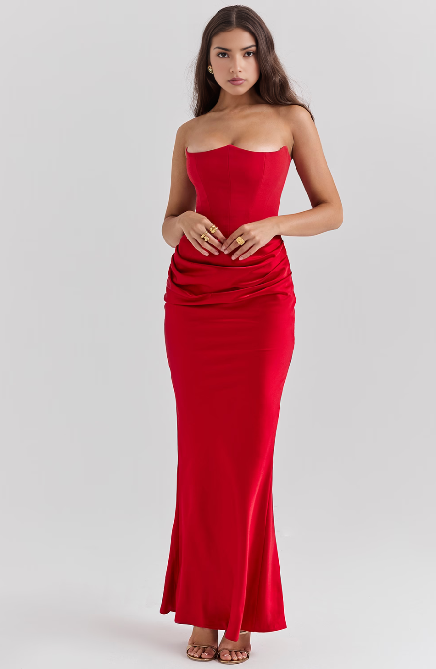 Full-length red strapless corset maxi dress with ruched waist detail and sweetheart neckline.