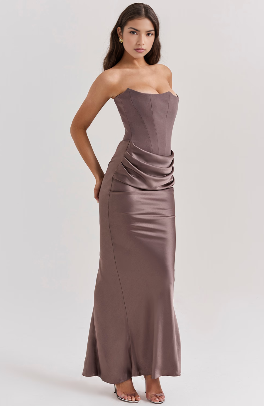 Side view of a taupe strapless corset maxi dress with sculpted bodice and elegant ruched waist.