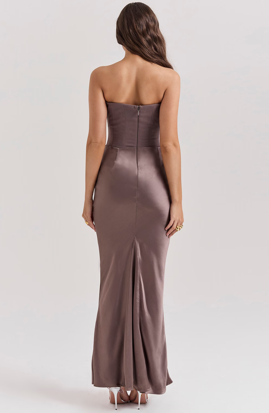 Back view of a taupe strapless corset maxi dress, showing the zipper and subtle train.