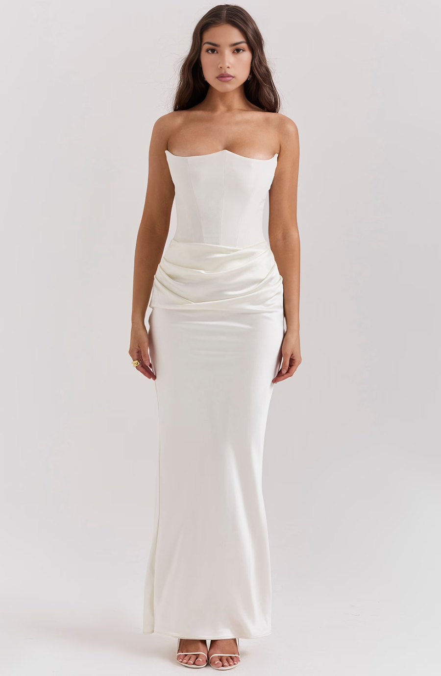 Full-length white strapless corset maxi dress with a sweetheart bodice and draped ruched waist.