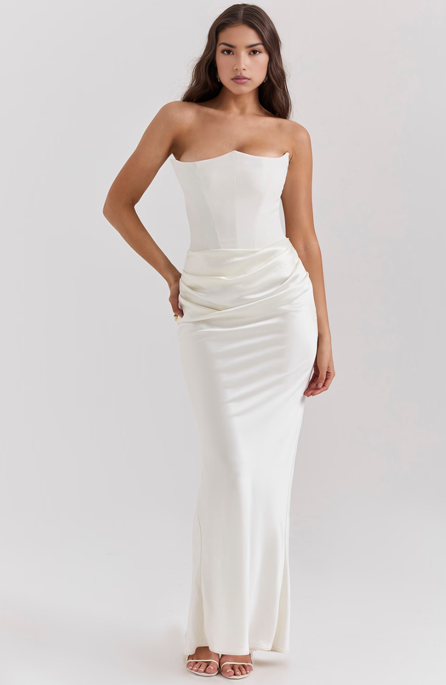 Side pose of a white strapless corset maxi dress, highlighting the fitted silhouette and ruched detailing.
