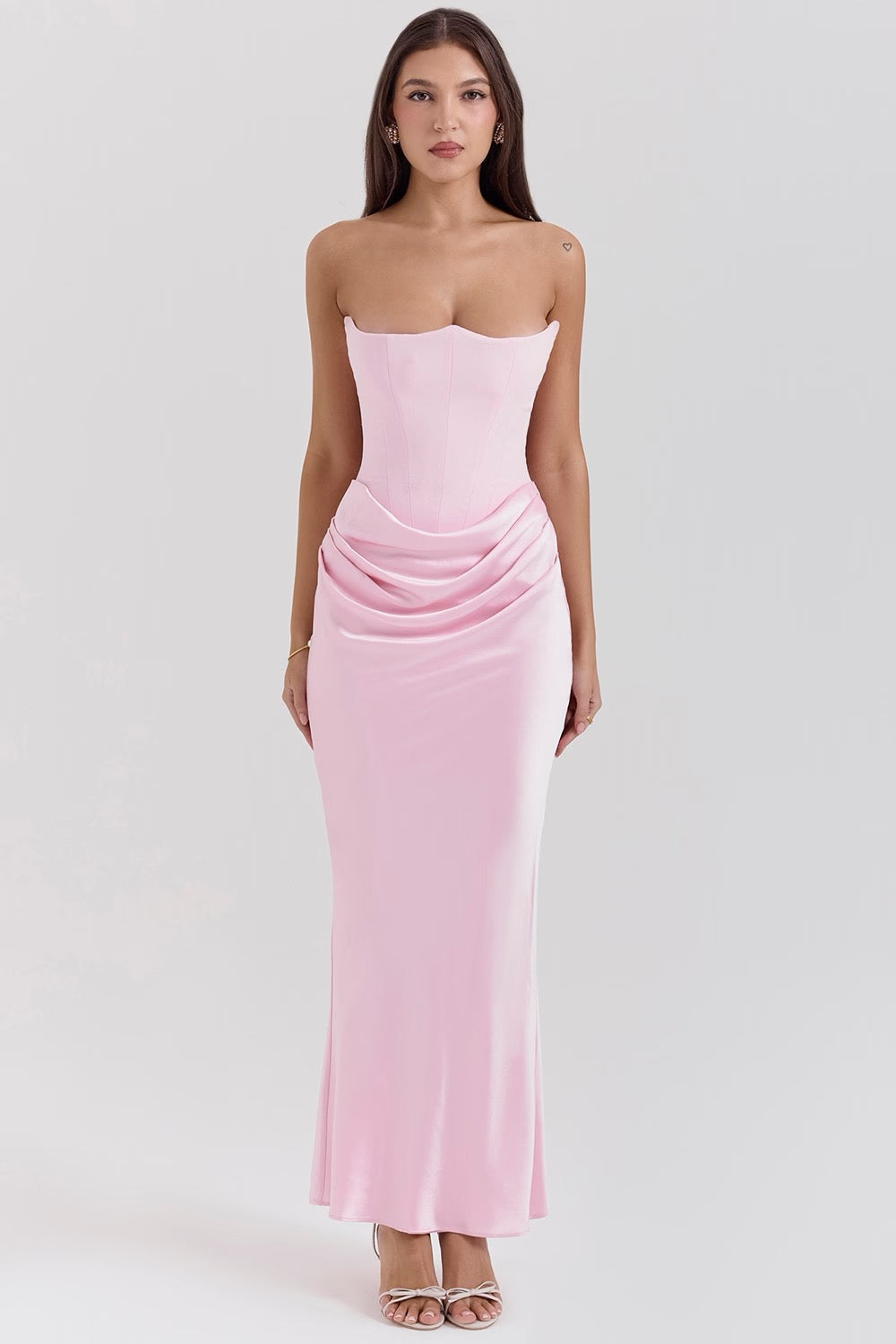Front view of a light pink strapless corset maxi dress, showcasing the structured bodice and flowing skirt.