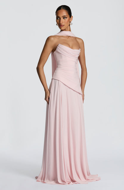 Front view of a light pink strapless cowl neck maxi dress with a long scarf detail draped over the shoulder.