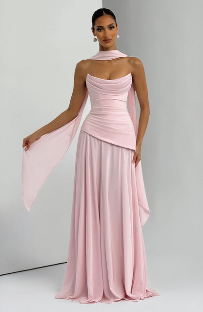 Soft pink strapless cowl neck maxi dress with a pleated skirt and long, delicate sashes flowing from the bodice.