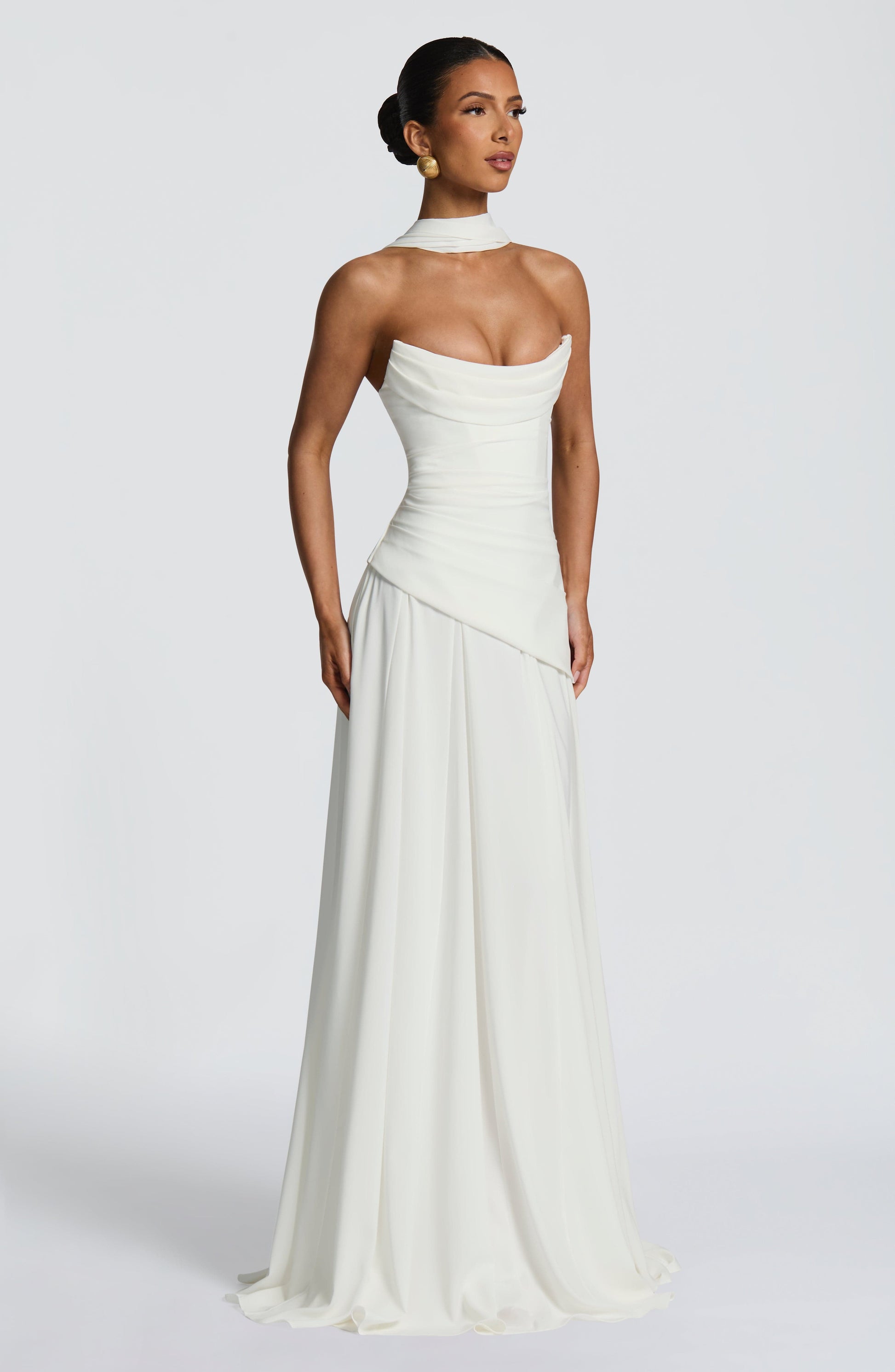 Front view of a white strapless cowl neck maxi dress, featuring a fitted bodice and a gently pleated skirt.