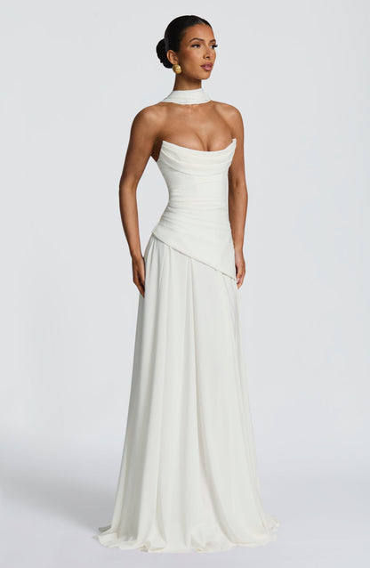 Front view of a white strapless cowl neck maxi dress, featuring a fitted bodice and a gently pleated skirt.