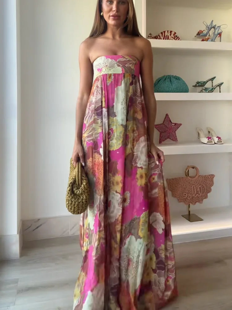 Close-up of the women's strapless floral printed maxi dress highlighting the intricate floral pattern in pink, green, and yellow, with a relaxed fit.