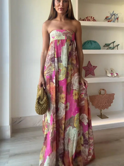 Close-up of the women's strapless floral printed maxi dress highlighting the intricate floral pattern in pink, green, and yellow, with a relaxed fit.