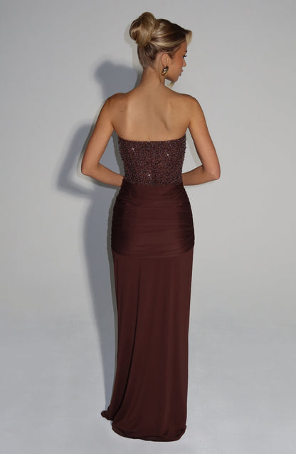 Back view of a women's dark brown strapless formal maxi dress featuring a sequined bodice and ruched waist detail.