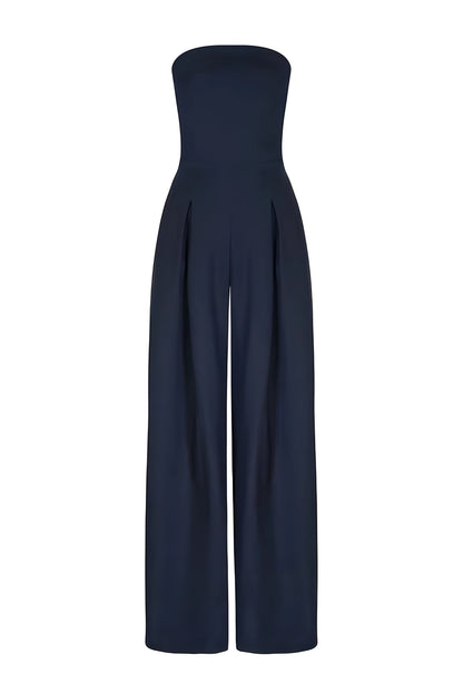 Front view of a dark navy women's strapless high-waisted wide-leg jumpsuit, showcasing the smooth fabric and pleated waist details on a white background.