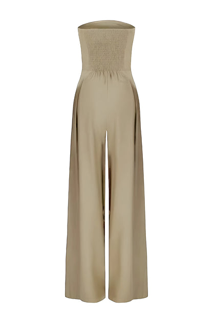 Back view of a beige strapless high-waisted wide-leg jumpsuit for women, showing the smocked detail on the back of the bodice, on a white background.
