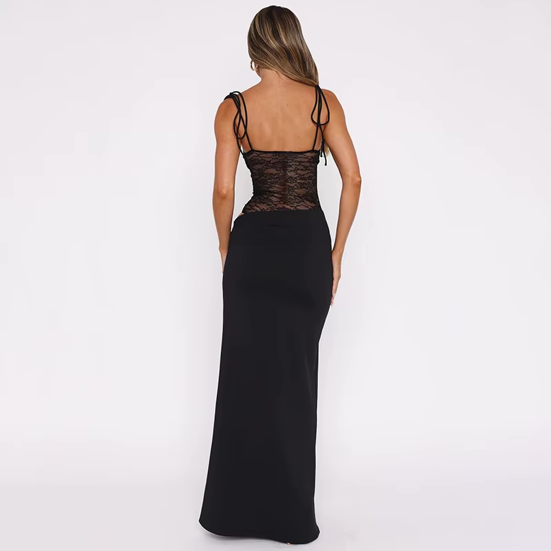 Back view of a woman in a black strapless lace cut out maxi dress, showcasing the lace bodice and tie-shoulder straps.