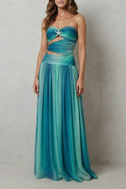 Front view of a women's strapless ombre maxi dress in shades of teal and blue, featuring a starfish embellishment and waist cut-outs.
