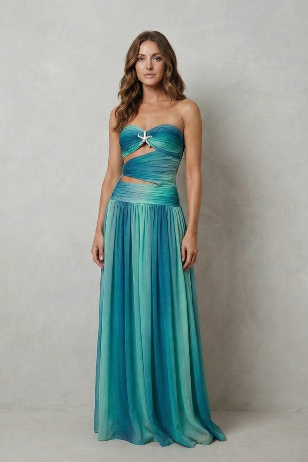 Elegant women's strapless printed maxi dress with a twisted bust and starfish detail, showcasing a beautiful blue and teal ombre.
